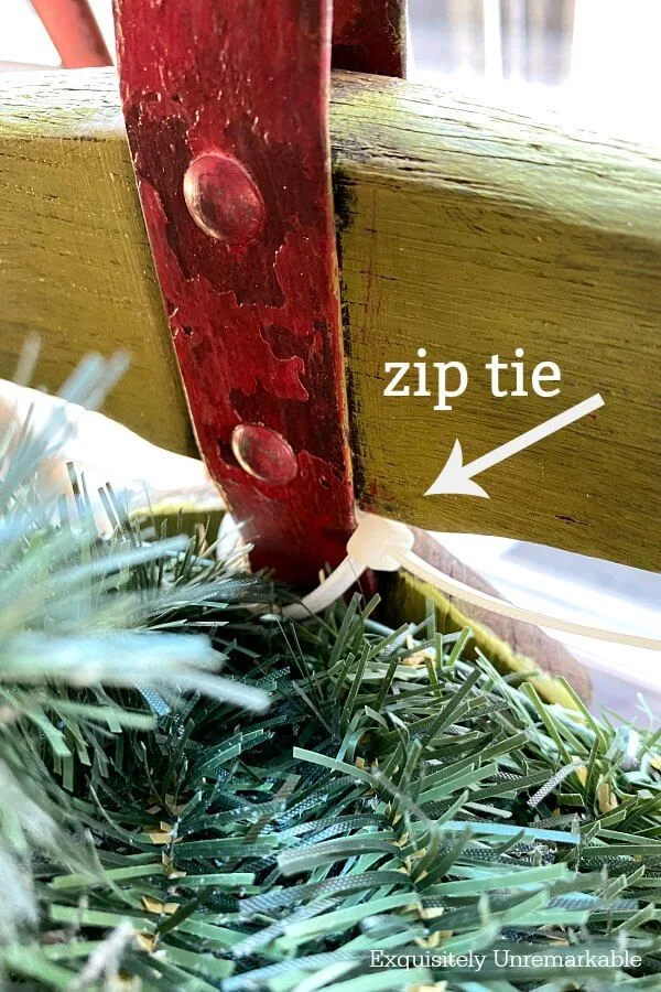 Using A Zip Tie To Attach Wreath To Sled