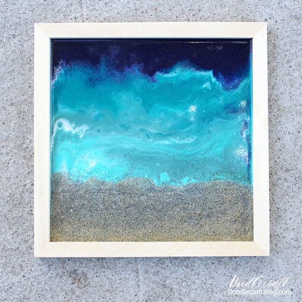 Use glossy resin to make the perfect ocean pour including a little beach sand. Great for beach-inspired home decor.