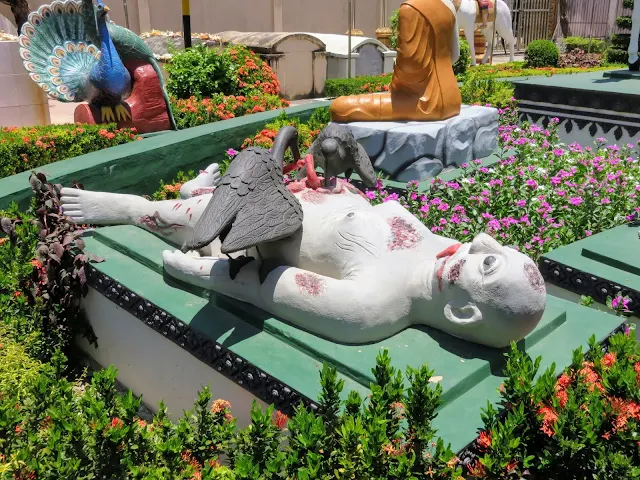 Statue of a corpse being eaten by birds at Wat Preah Prom Rath temple in Siem Reap Cambodia