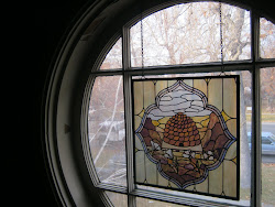 The Magical Round WIndow in the hall upstairs--now with a pioneer beehive and sego lilies . . .