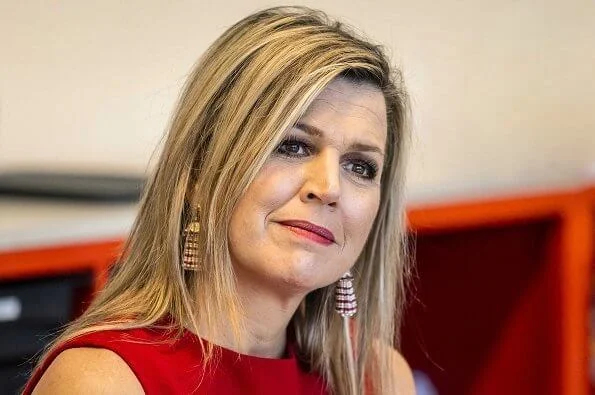 Queen Maxima wore a red coat and red sleeveless dress from Natan. Oscar de la Renta earrings