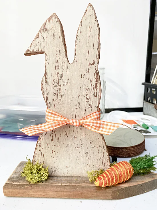 chippy bunny on the workshop table with bow and carrot
