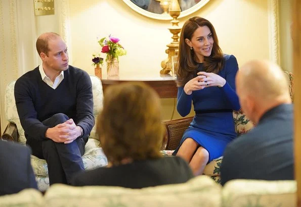 Kate Middleton wore Mulberry blue Ashleigh cape coat and a new Jenny Packham dress.The Duchess is wearing a cape coat by Mulberry