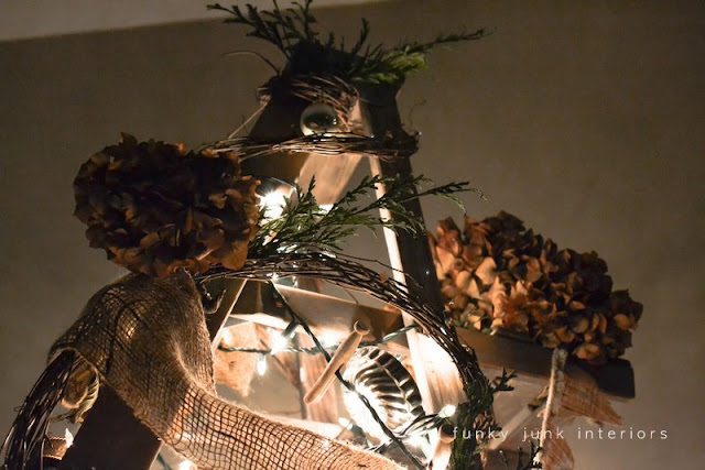 A night picture of a treeless ladder Christmas tree, decorated with twig garland and hydrangeas, by Funky Junk Interiors A night picture of a treeless ladder Christmas tree, decorated with twig garland and hydrangeas, by Funky Junk Interiors
