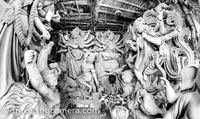 Recently I visited Kolkata and as told by blogger friends that it's best time to visit Kumartuli in the city. We spend half a day walking around the streets of Kumartuli and it's not only about Idol making, but much more than that. Localities of Kumartuli share a lot about Kolkata and it's cultural inclinations. This Photo Journey shares some of the photograph's clicked by TravellingCamera. Kumartuli is derived from Coomar-toli and now every Indian can make out the meaning. This place is residence of all artists who make Durga puja idols, which are used in different pandals of Kolkata and outside India.If you plan to visit Kumartuli and do photography, please ensure that you buy the ticket from committee office. A ticket costs 50 rs and then you can freely roam around. I found it a good practice. This way, committee also makes some money and as a photographer you are not scared that people would say weird things to you. I have had bad experiences shooting in old delhi and sort of scared clicking photographs in streets. Kumartuli photography is becoming popular and many of the great photographs have created masterpieces in the streets of Kumartuli.All the streets of Kumartuli are full of workshops where Durga Puja idols are made. Different families own these workshops and almost all of them have different styles of making these idols. At a basic level, all these idols look similar except sizes. But when they start doing minor changes for final finishing, one can make out the clear difference.There are different stages to the whole process making Durga Puja Idols. On Akshaya Tritiya, clay for the sculptures is collected from the banks of Ganges. A handful of soil (punya mati) is collected from the nishiddho pallis of Calcutta, where sex workers live and adding it to the clay mixture which goes into the making of the Durga sculpture.After the required rites, the clay is transported. An important event is 'Chakkhu Daan', literally donation of the eyes. Starting with Devi Durga, the eyes of the sculptures are painted on Mahalaya or the first day of the pujas. Before painting on the eyes, the artisans fast for a day and eat only vegetarian food.Kumartuli history is very interesting. When East India Company decided to build new settlement Fort William at the site of the Gobindapur village, many existing population shifted to Sutanuti. Neighbourhoods like Jorasanko and Pathuriaghata became the centres of the local rich. Separate districts were allotted to the Company’s workmen - Suriparah for wine sellers, Collotollah for folks dealing in oil, Chuttarparah became carpenters hub, Aheeritollah - cowherd’s quarters and Coomartolly  for potters. Now potters of Kumortuli make gods and goddesses, worshipped in large numbers in the mansions all around and later at community durga pujas in Kolkata and outside the country.Streets of Kumartuli are most busy from the month of August till October, although artists start getting orders in April. Most of the artists of Kumartuli are busy throughout the year and they get orders from different parts of the worlds.When I talked to one of the artists of Kumartuli, he told us some interesting facts about Durga Puja and it's preparations. It seems that different streets of Kolkata have different pandal for Durga puja and a contest is run in whole city. Best Durga-Puja Pandals are given prizes and local media remains focussed on these activities.Not very sure, but it seems that artists of Kumartuli don't earn much. Like many other businesses in India, middle men earn One of the artist mentioned that some of the artists visit them during different stages of idol making and ensure that idols are made as per their choice. Such clients know well about this form of art and have valid comments most of the times. We could some of the such clients who were there to ensure that things are working fine or to suggest changes.It was a brilliant experiences to walk through the streets of Kumartuli. At every 5 steps, you see a new workshop working on different kinds of Durga idols. And these streets tell you much more about Kolkata and not only about the idol making process.While walking thought the streets of Kumartuli, we were wondering about the state of these Artists. It seemed that most of these artists dwell in poor living conditions. There are some popular families in KUmartuli who have been doing this for many years. Popular among them are Mohan Banshi Rudra Pal, his sons Sanatan Rudra Pal and Pradip Rudra Pal, Rakhal Pal, Ganesh Pal, Aloke Sen, Kartik Pal, Kena Pal, who are still reigning figures of Kumortuli. The good part is that most of the major clients come to these families who better know the art of idol creation.Women are not lagging behind. Kumortuli boasts of the presence of some 30+ women artisans, like Minati Pal, Soma Pal, Kanchi Pal and Chapa Rani Pal. They have been in the business of idol making for a long time. For more, check out this link. Some of the workshops were working on few project but huge in scale. Their style and details were also unique. Check out the photograph above and the one shared below. Look at the the details in these photographs.Have a closer look at this photograph and garland. This garland is made up of hundreds of art-pieces you see in the photograph below.Most of these artists have to work late-night during August-Oct. Some of these artists get lot of orders and they need to work extra to accomplish them with good quality.Some friends from Kumartuli :) . One of them was following us after we clicked this photograph. She used to stop as we look back.When main structures are in shape, heads, fingers and other detailed pieces are added.Some of the workshops had already started the coloring process, which is one of the final steps of idol making process.