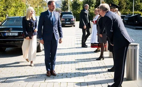 Crown Princess Mette Marit wore a seth double breasted gabardine blazer from Altuzarra, and crepe ivory wide-leg pants from Michael Kors