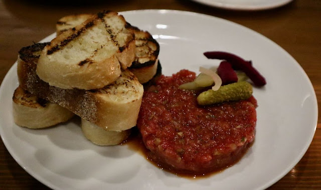 Steak Tartare at the Marc Edmonton served with cornichons, house made pickles and croutons