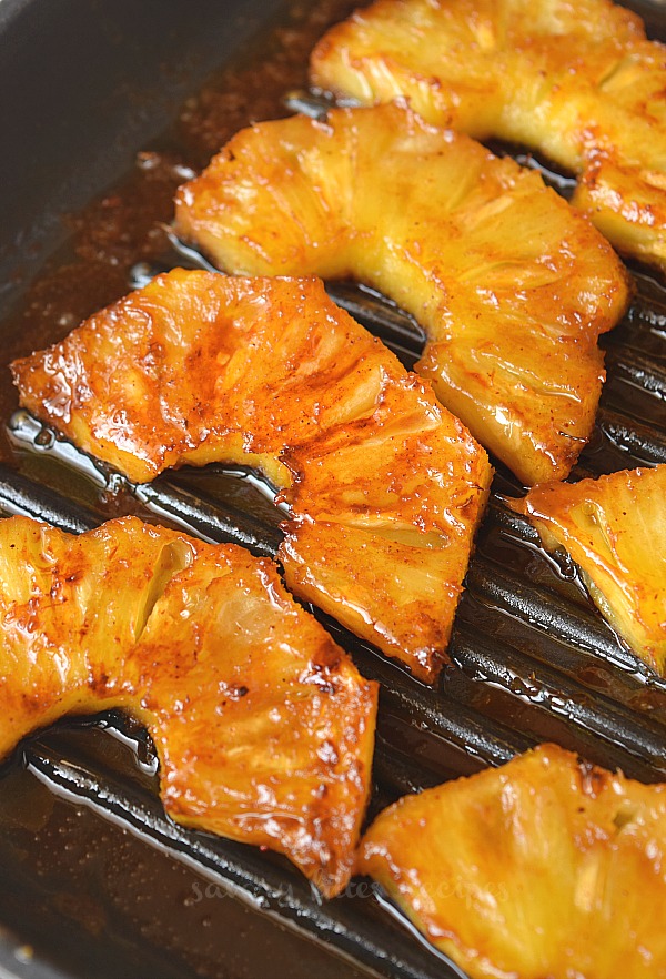 brown sugar and cinnamon grilled pineapple slices in a pan