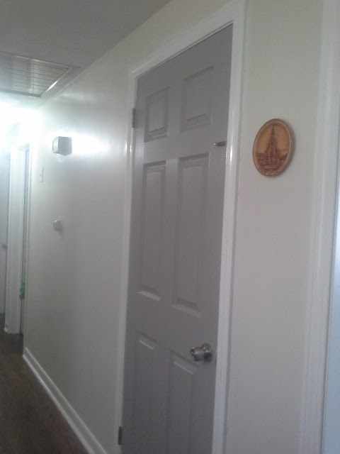 Hallway painted white trim grey doors