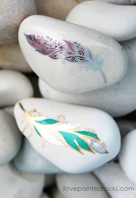 painted rock ideas with metallic feather designs