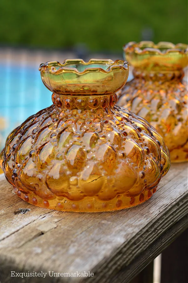 Vintage Amber Glass Lampshades on deck railing