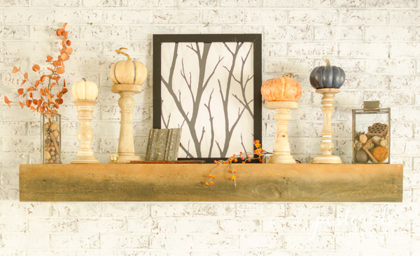 fall mantel with pumpkins and branches