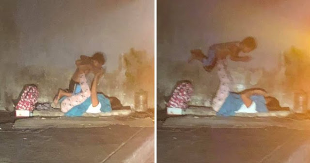 Powerful Pictures Of Homeless Mother Playing With Her Son In The Midst Of A Traffic Jam