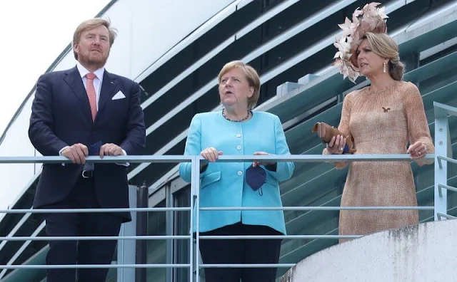 Queen Maxima wore a brown dress from Natan Edouard Vermeulen, and a leaf style hat from Berry Rutjes. Chancellor of Germany Angela Merkel