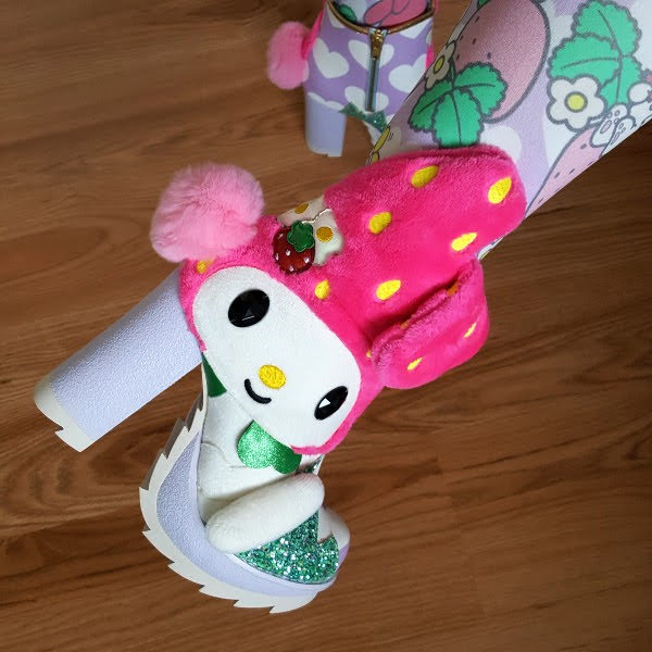 close up of foot wearing Sanrio My Melody ankle boot with furry bunny detail and large platform