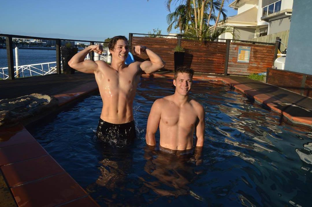 two-fit-shirtless-wet-hunky-young-pool-guys-biceps-flex