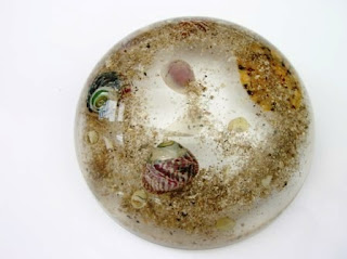 Paperweight containing shells and sand taken from the beach
