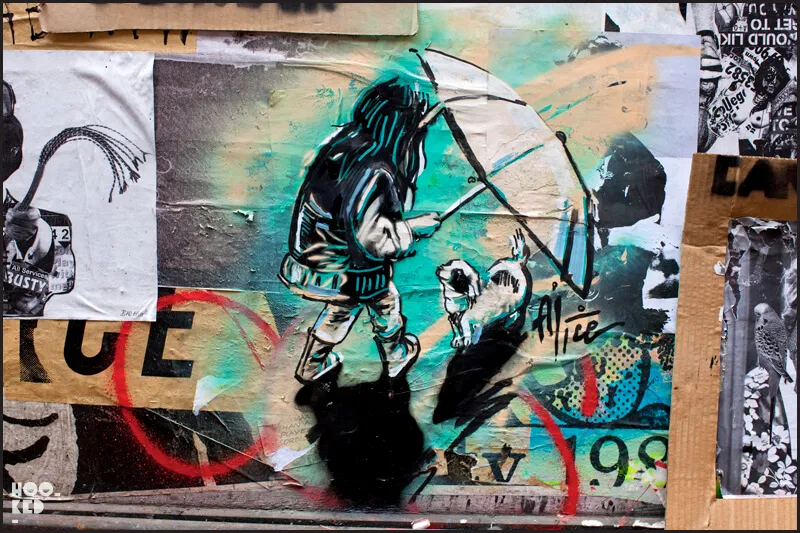 London street art by Alice Pasquini featuring a girls with an umbrella and small dog