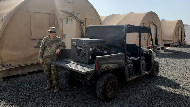 Army Lt. Col. Jason Barnhill, a faculty member of West Point and USU’s Department of Radiology, poses for a photo with the 3D printer.