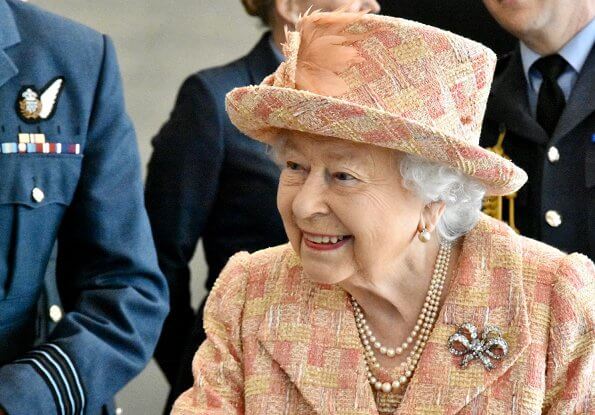 As Honorary Air Commodore, Queen Elizabeth. She wearing a peaches and cream outfit with matching hat by Angela Kelly. diamond bow brooch
