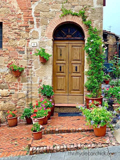 Tuscan exterior door decor with pots and flowers 
