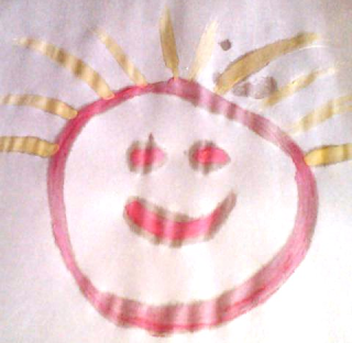 Happy face drawn with pink watercolor paint with yellow hair.