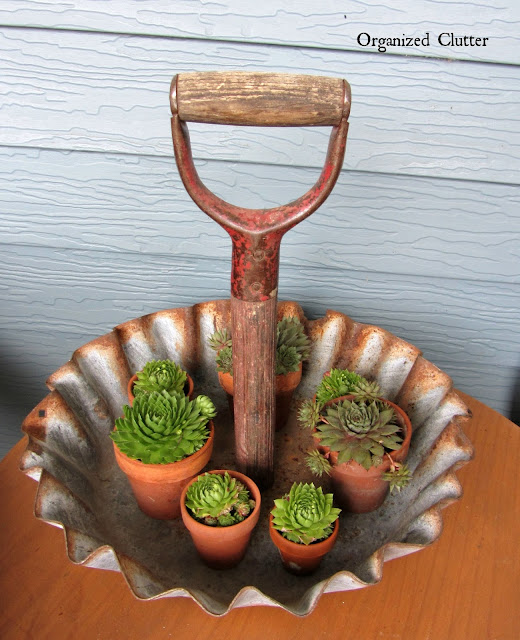 Photo of a junky display tray made with a shovel handle and fluted farm tray.