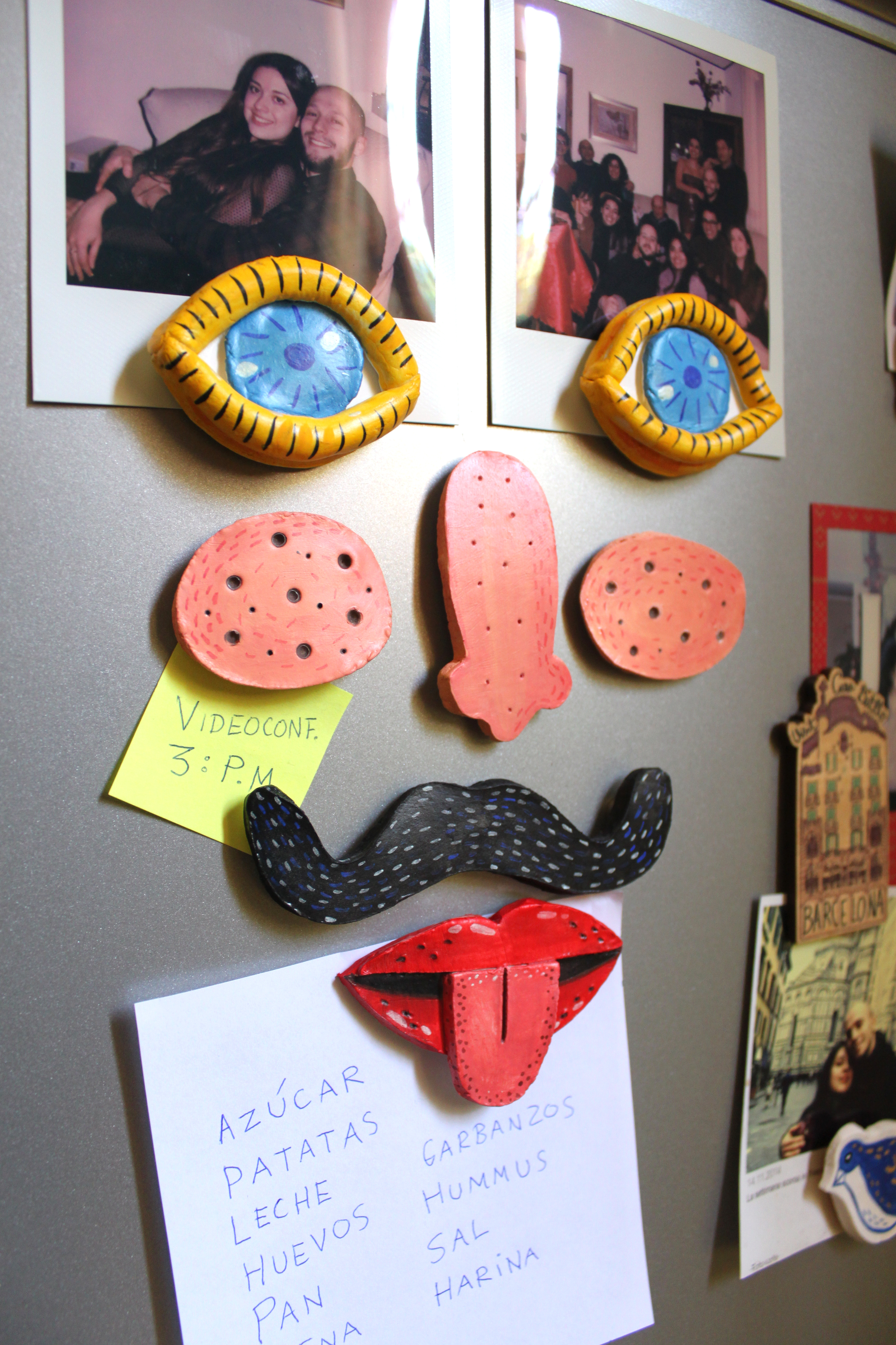 Clay face magnets in a fridge