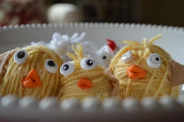 Yellow Yarn Chickens in a white ceramic bowl