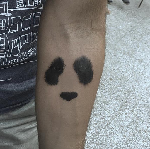 Diese negative space panda tattoo