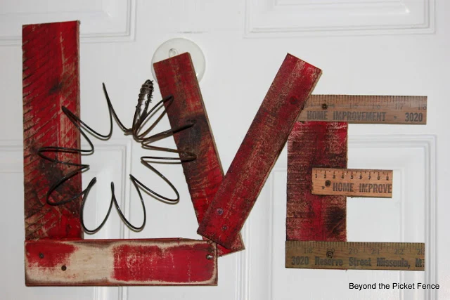 Junk-styled-LOVE-sign-with-reclaimed-wood-by-Beyond-the-Picket-Fence-featured-at-I-Love-That-Junk