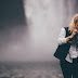 Elegant woman in front of a waterfall