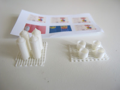Components of a 3D-printed modern dolls' house miniature spray can kit.