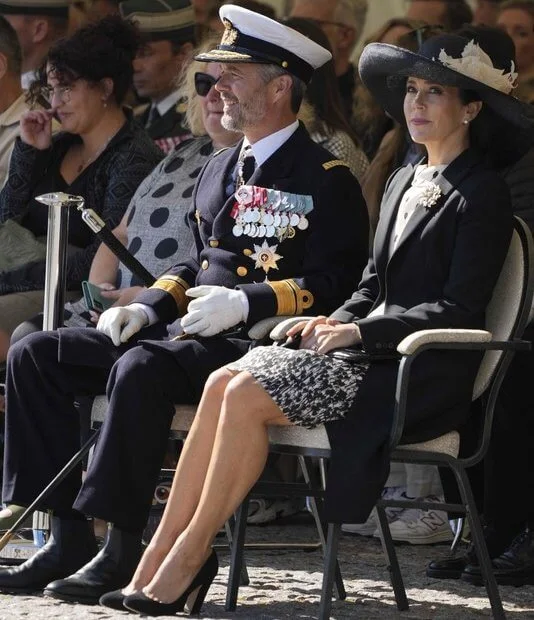 Crown Princess Mary wore a cappotto black coat by Prada, and printed silk dress by MaxMara. Jimmy Choo Billie pumps