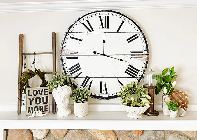 mantel with cement bowls and large clock