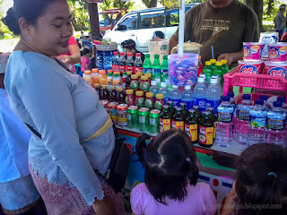 A Mother Buys Her Children Food And Drinks In A Tradisional Stall At The Temple Area