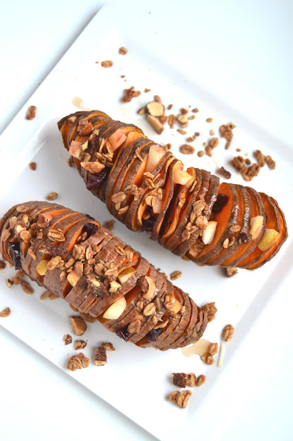 Stuffed Hasselback Sweet Potatoes- loaded with sweet apples, dried cherries, pecans, maple syrup and protein granola for breakfast or dessert! www.nutritionistreviews.com