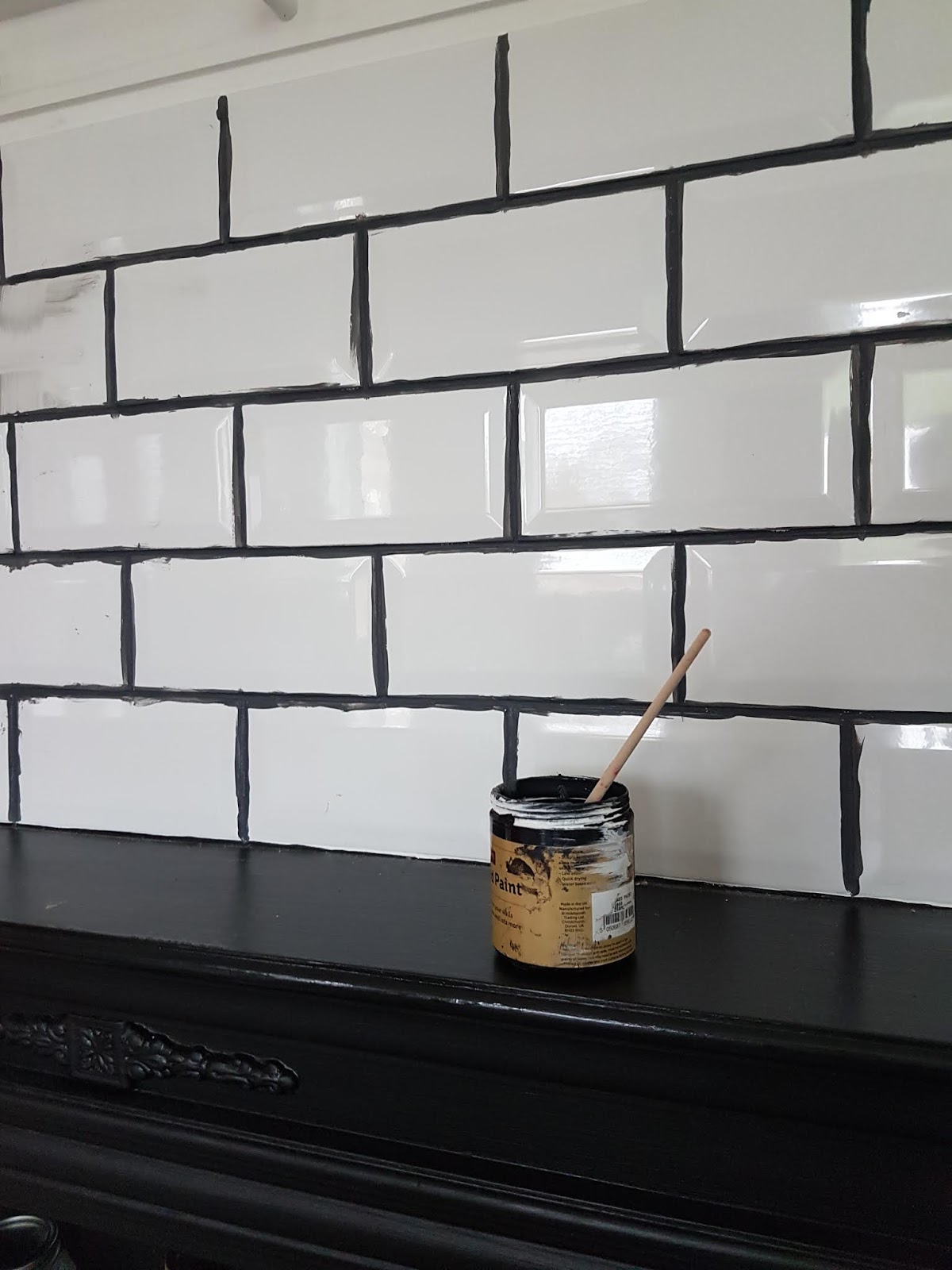 Painting grout lines.
