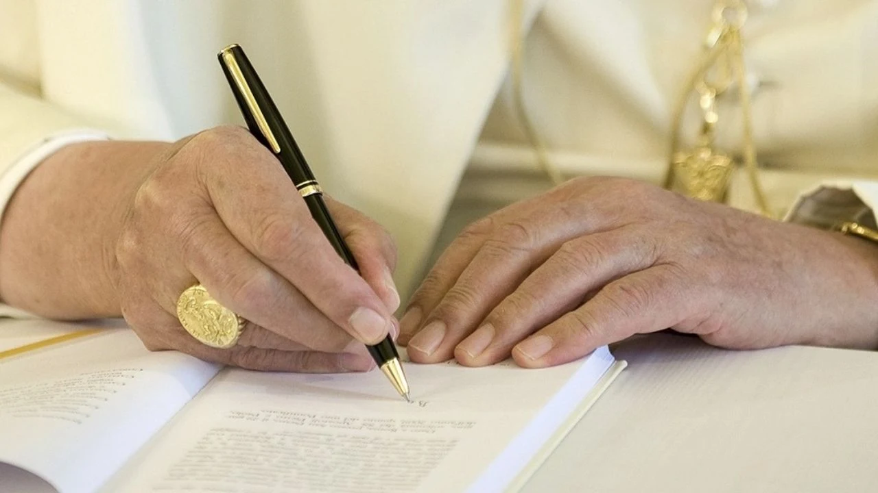 Encyclical: Pope signing a paper