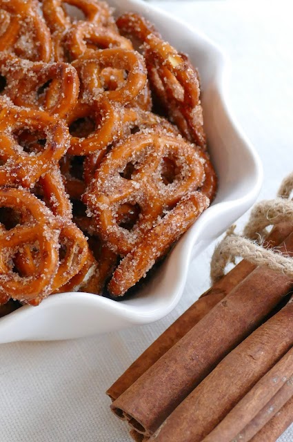pretzels in a bowl with cinnamon sticks on the side.
