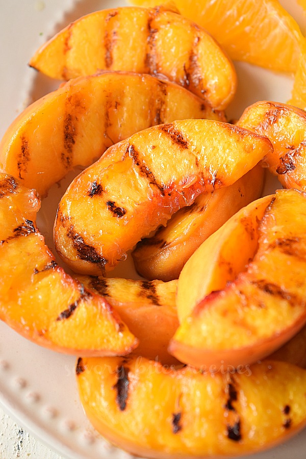 close up of a plate with grilled peaches