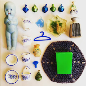 Flatlay of vintage dolls' house miniatures in blue and green colours.