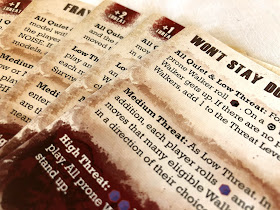 A selection of event cards from The Walking Dead: All Out War miniatures game