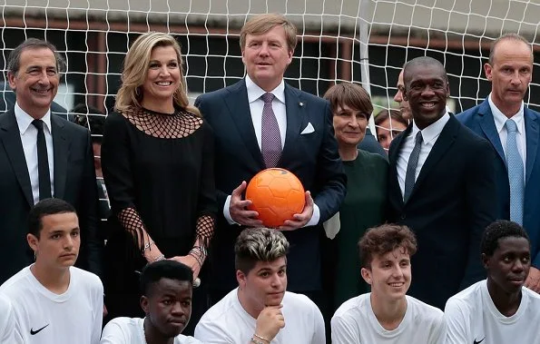 Queen Maxima and King Willem-Alexander attended a Football Clinic. Queen Maxima wore black long dress in Milan