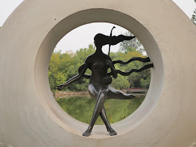 sculpture of a woman playing an erhu