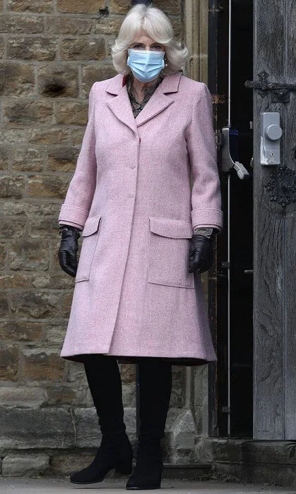 The Duchess met with those involved in the vaccination process, including NHS staff, volunteers and representatives. Pink wool coat and black boot