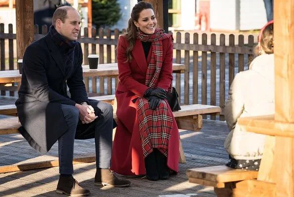 Kate Middleton wore a tartan pleated skirt from Emilia Wickstead, yellow gold hoops from Spells of Love. Alexander McQueen red coat. Grace Han bag