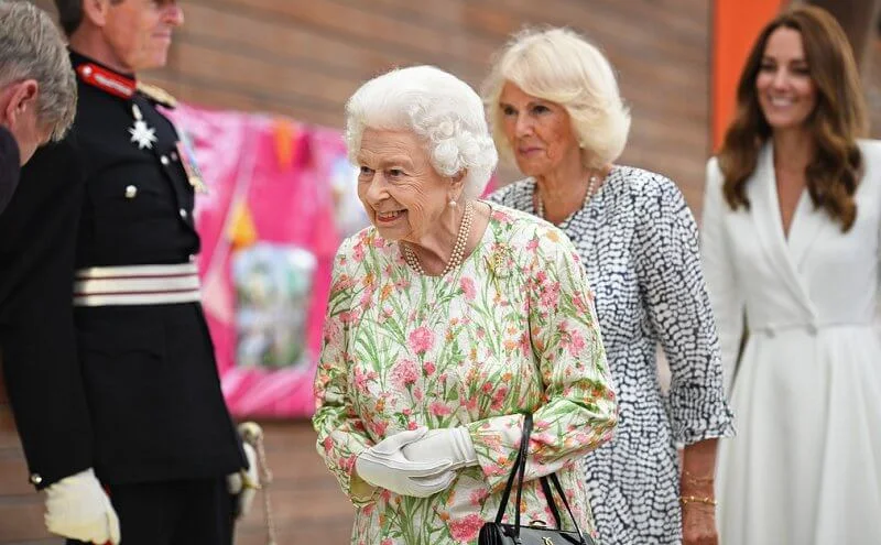 Queen in a floral outfit, Kate  in white coat dress, Carrie Johnson, wore a dressby Vampire’s Wife, Jill Biden in trench coat