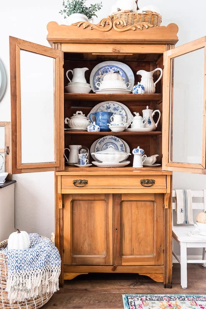 pine hutch with white ironstone, blue and white transferware and decoupage pumpkins