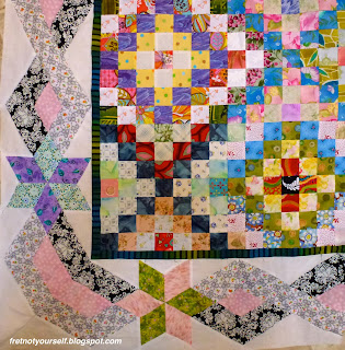 Multi-colored quilt in a Trip Around the World variation; narrow green and black inner border; larger outer border of stars with braided black and white fabrics.